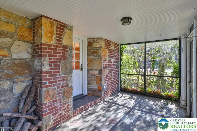 a kitchen with stainless steel appliances a stove a sink and a chandelier