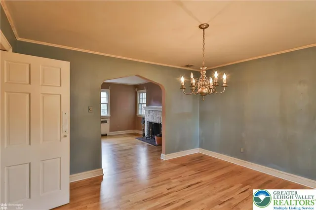 a kitchen with stainless steel appliances granite countertop a refrigerator a stove and a wooden floor