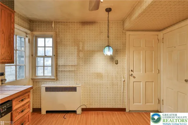 a view of an empty room and wooden floor