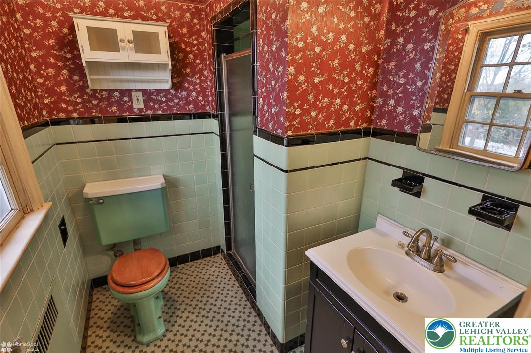 1104 Raymond Avenue Bethlehem, PA 18018 - Photo 38 of 67 a bathroom with a sink mirror vanity and toilet