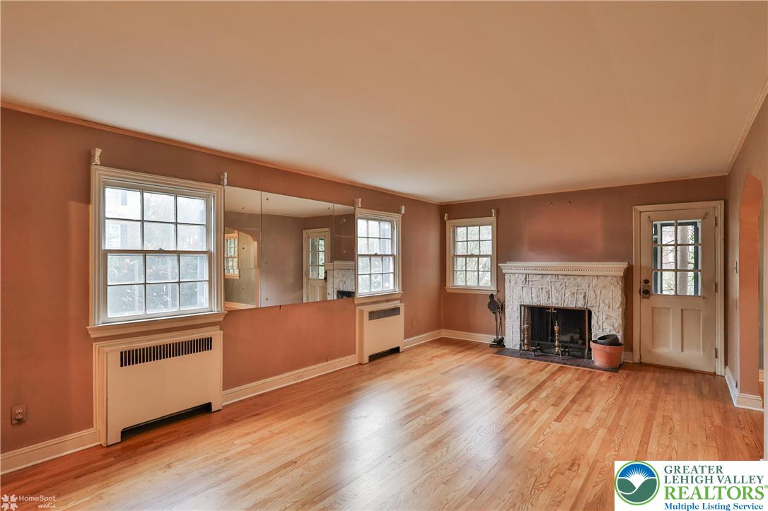 1104 Raymond Avenue Bethlehem, PA 18018 - Photo 8 of 67 an empty room with fireplace wooden floor and windows