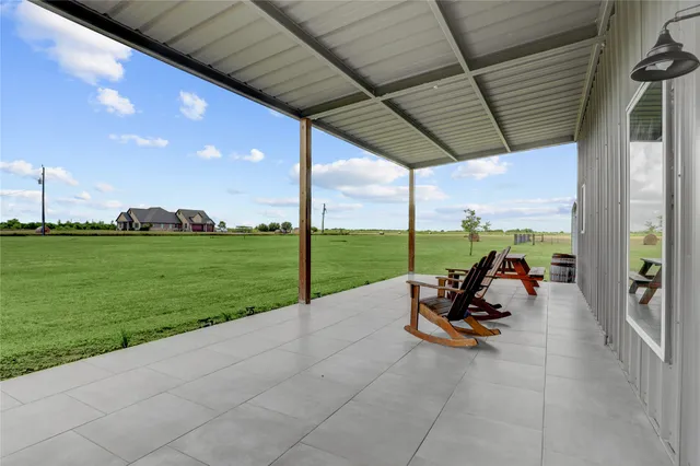 a view of a swimming pool and lounge chairs in backyard