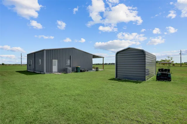 a view of a house with a backyard