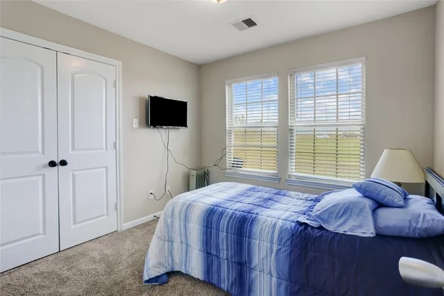 a bedroom with a bed and a television