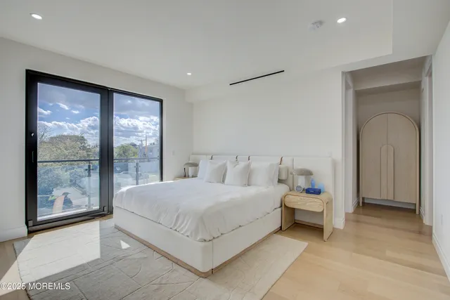 a bedroom with a bed and a large window