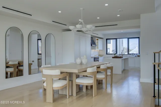 a view of a a dining room with furniture window and wooden floor