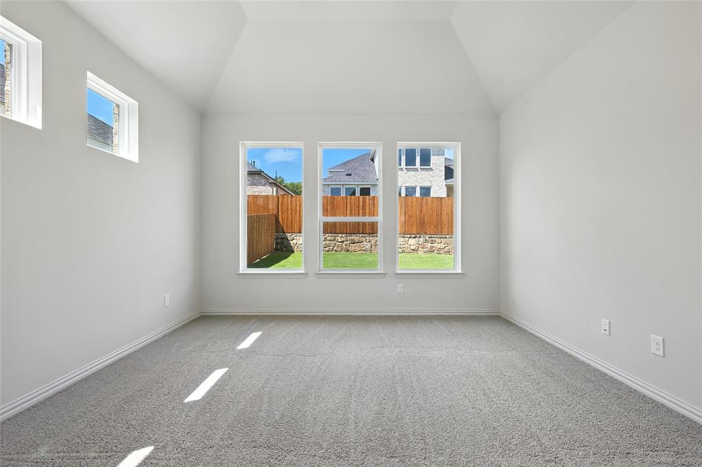1434 Odette Drive Arlington, TX 76013 - Photo 17 of 38 Unfurnished room featuring carpet floors and vaulted ceiling