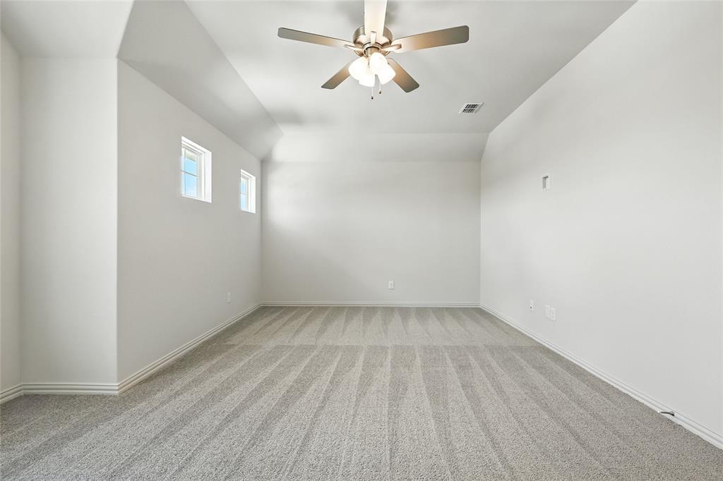 1434 Odette Drive Arlington, TX 76013 - Photo 28 of 38 Carpeted empty room featuring a ceiling fan and baseboards