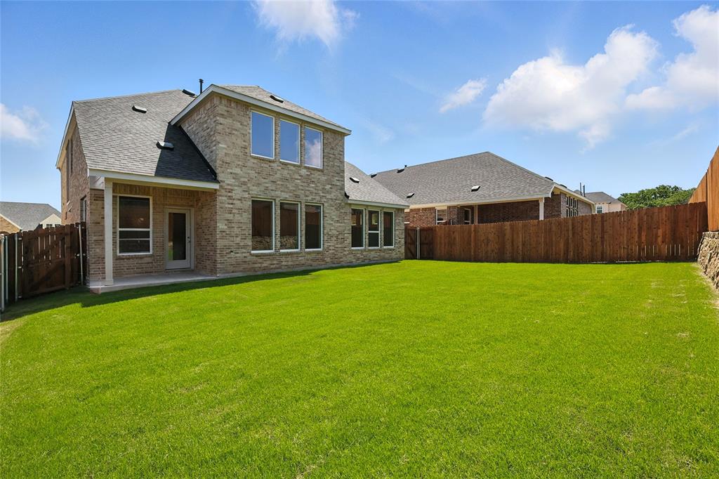 1434 Odette Drive Arlington, TX 76013 - Photo 32 of 38 Back of house with a fenced backyard, a shingled roof, brick siding, and a patio area