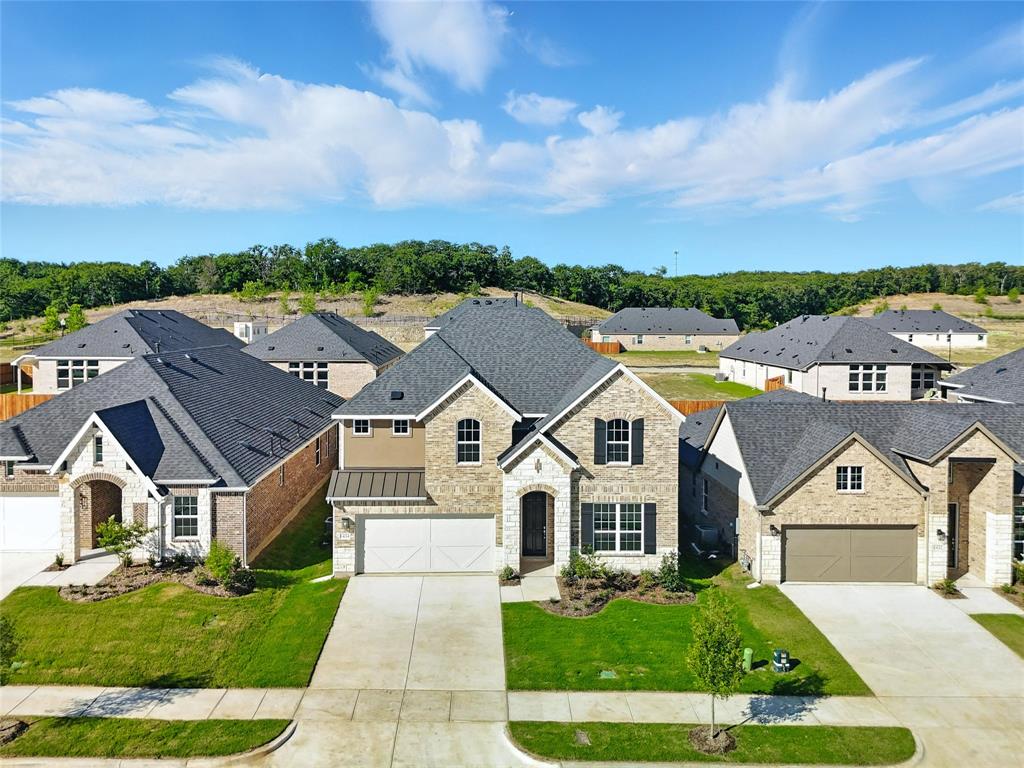 1434 Odette Drive Arlington, TX 76013 - Photo 36 of 38 French country style house featuring driveway, stone siding, a residential view, and a front yard