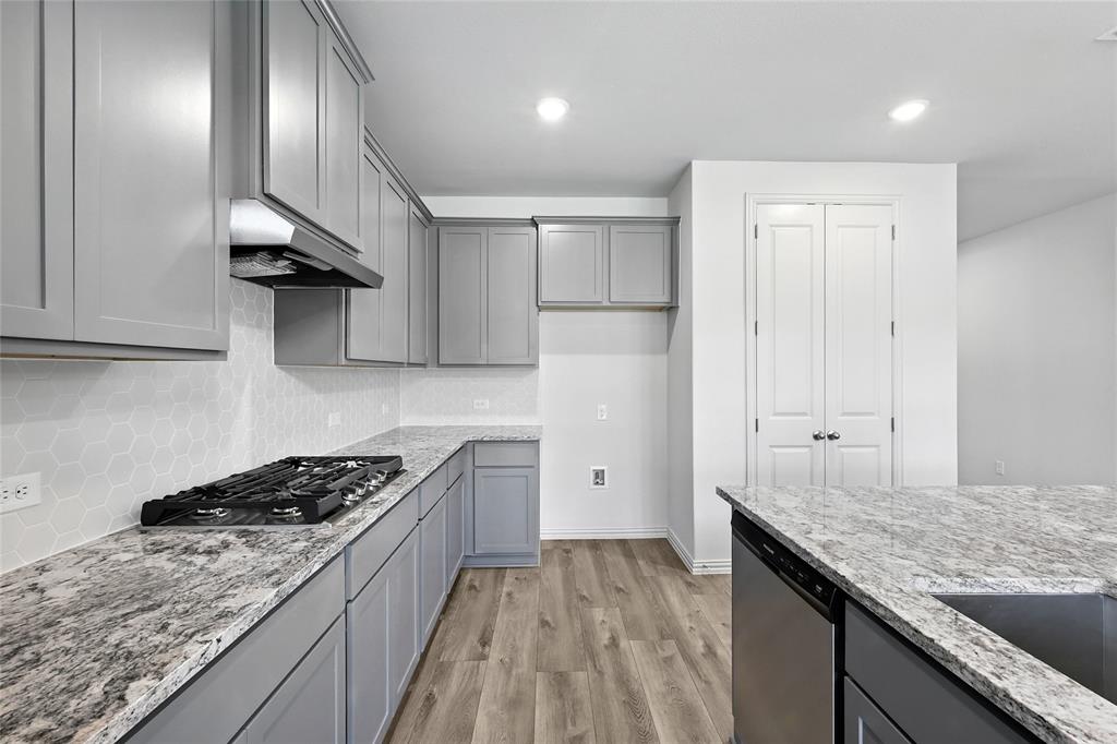 1434 Odette Drive Arlington, TX 76013 - Photo 7 of 38 Kitchen with appliances with stainless steel finishes, gray cabinetry, under cabinet range hood, light wood-style flooring, and recessed lighting