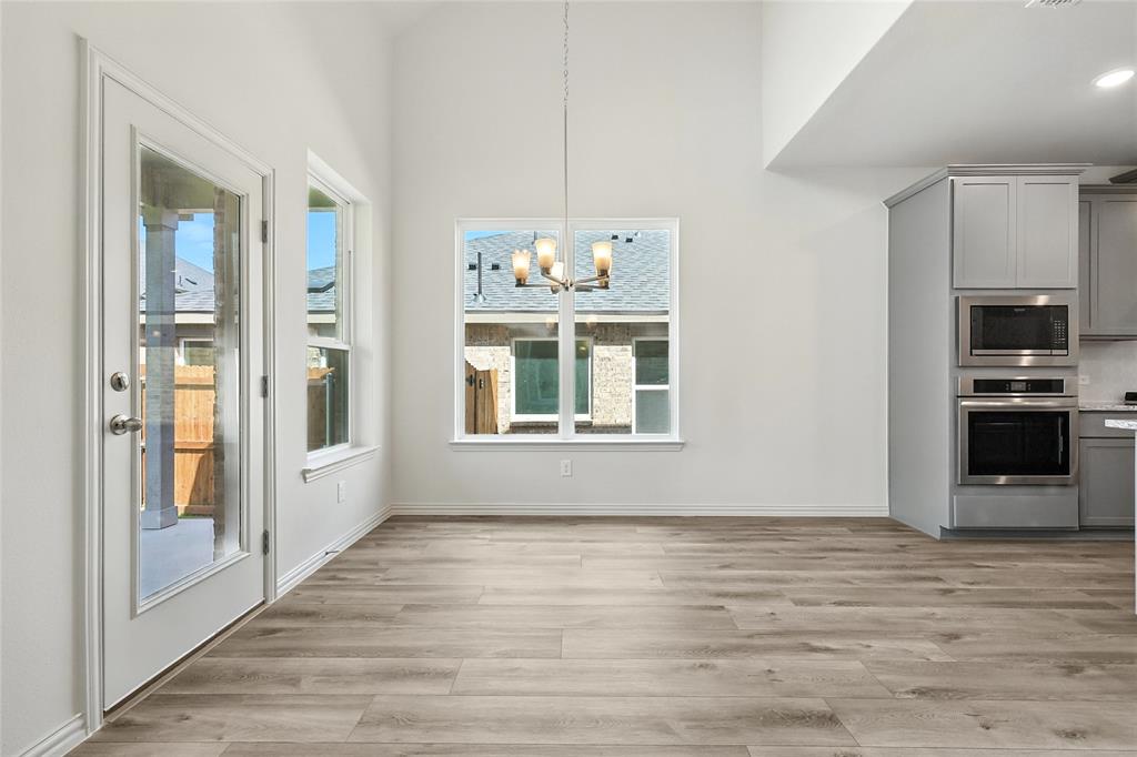 1434 Odette Drive Arlington, TX 76013 - Photo 10 of 38 Unfurnished dining area featuring a chandelier and light wood-style flooring