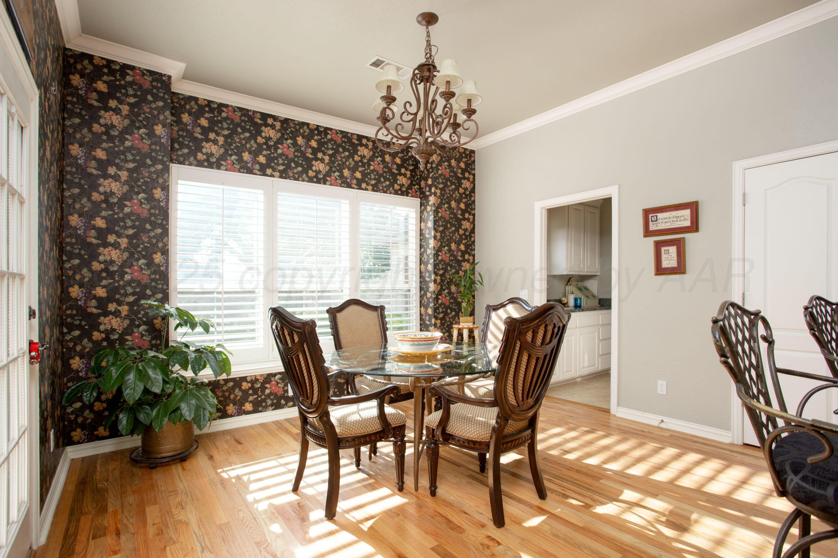 4823 Arden Road Amarillo, TX 79110 - Photo 19 of 53 a view of a dining room with furniture and a potted plant