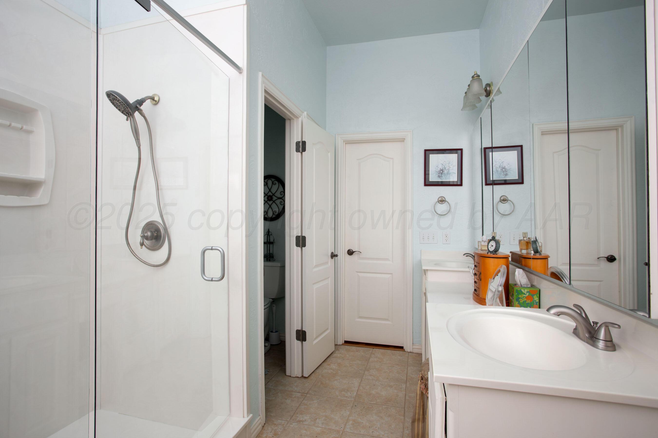 4823 Arden Road Amarillo, TX 79110 - Photo 28 of 53 a bathroom with a tub and shower