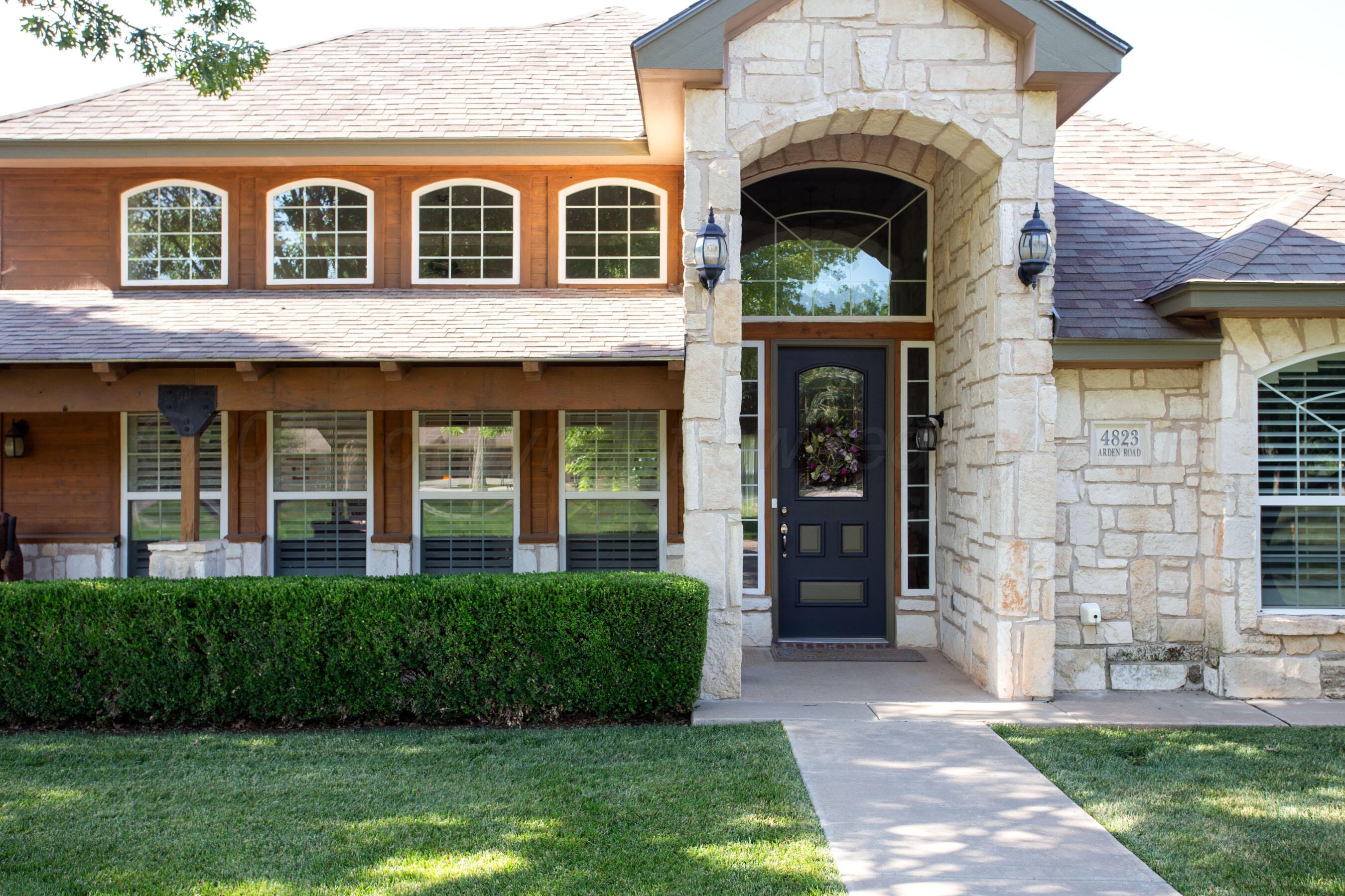 4823 Arden Road Amarillo, TX 79110 - Photo 3 of 53 a view of a brick house with a large windows and a yard with plants