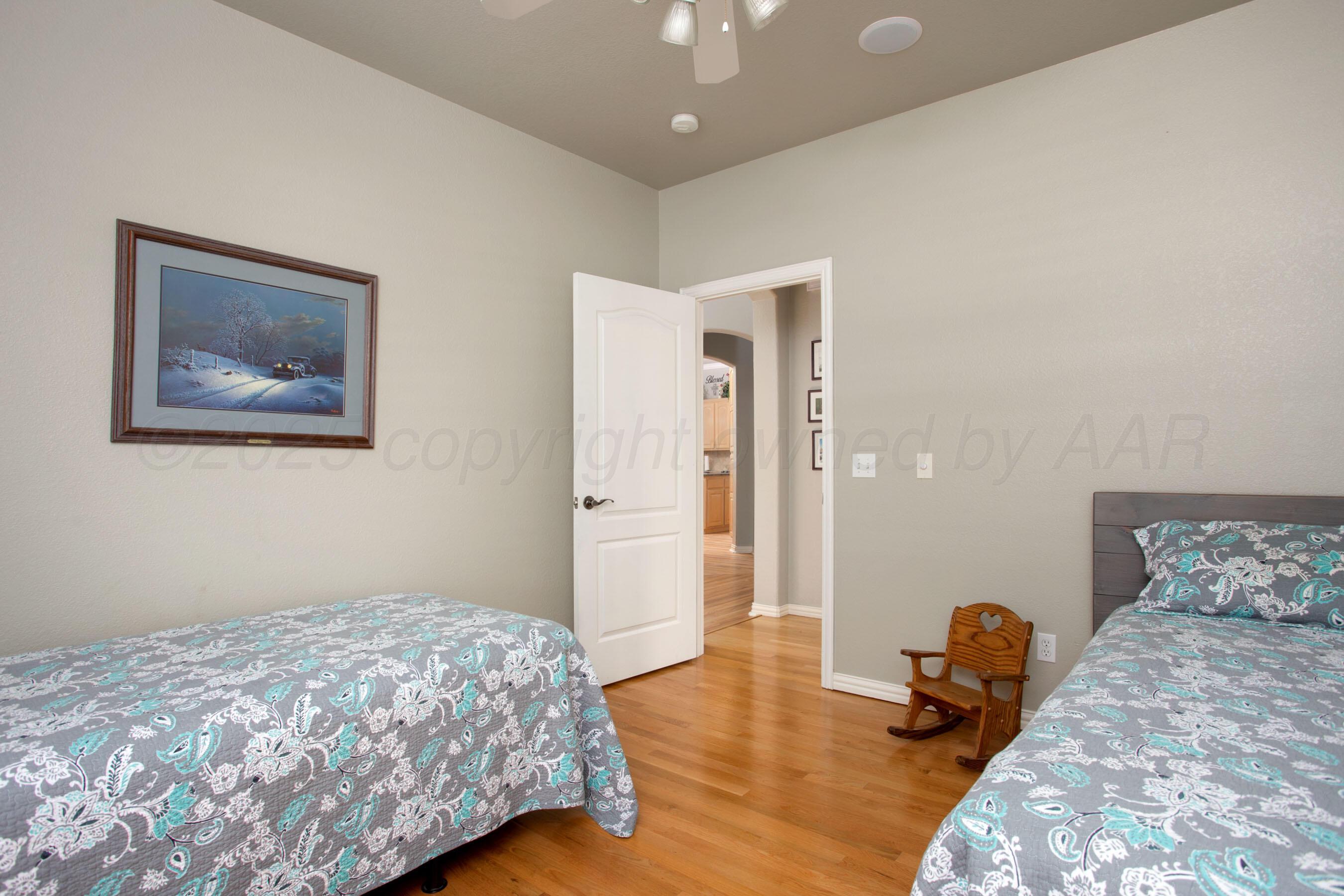 4823 Arden Road Amarillo, TX 79110 - Photo 31 of 53 a bedroom with a bed and wooden floor