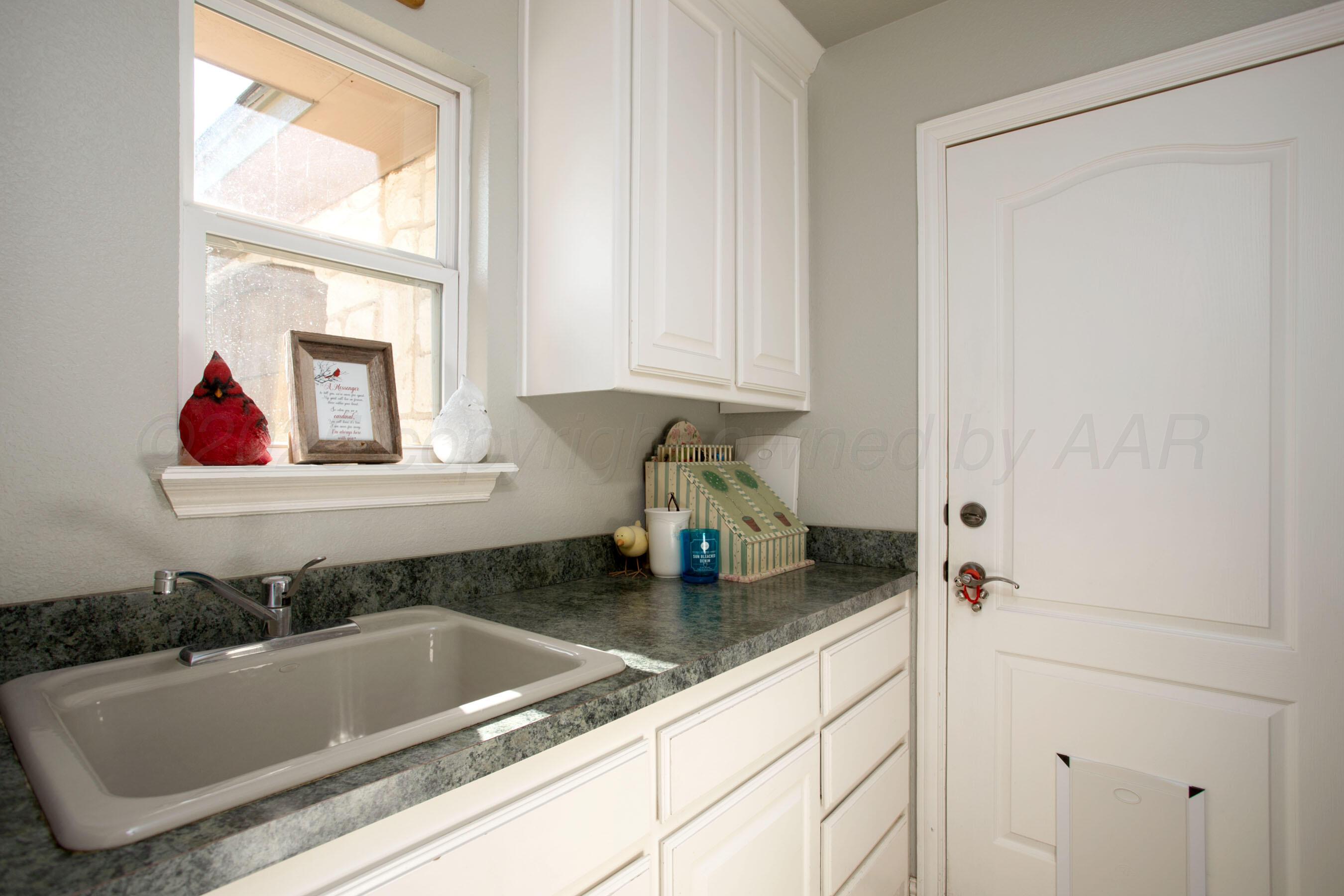 4823 Arden Road Amarillo, TX 79110 - Photo 36 of 53 a bathroom with a granite countertop sink and a window