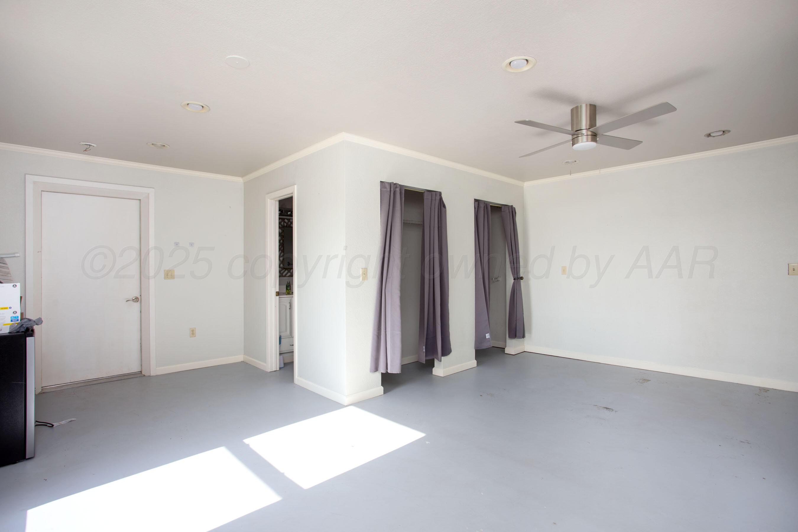 4823 Arden Road Amarillo, TX 79110 - Photo 46 of 53 an empty room with closet and a ceiling fan