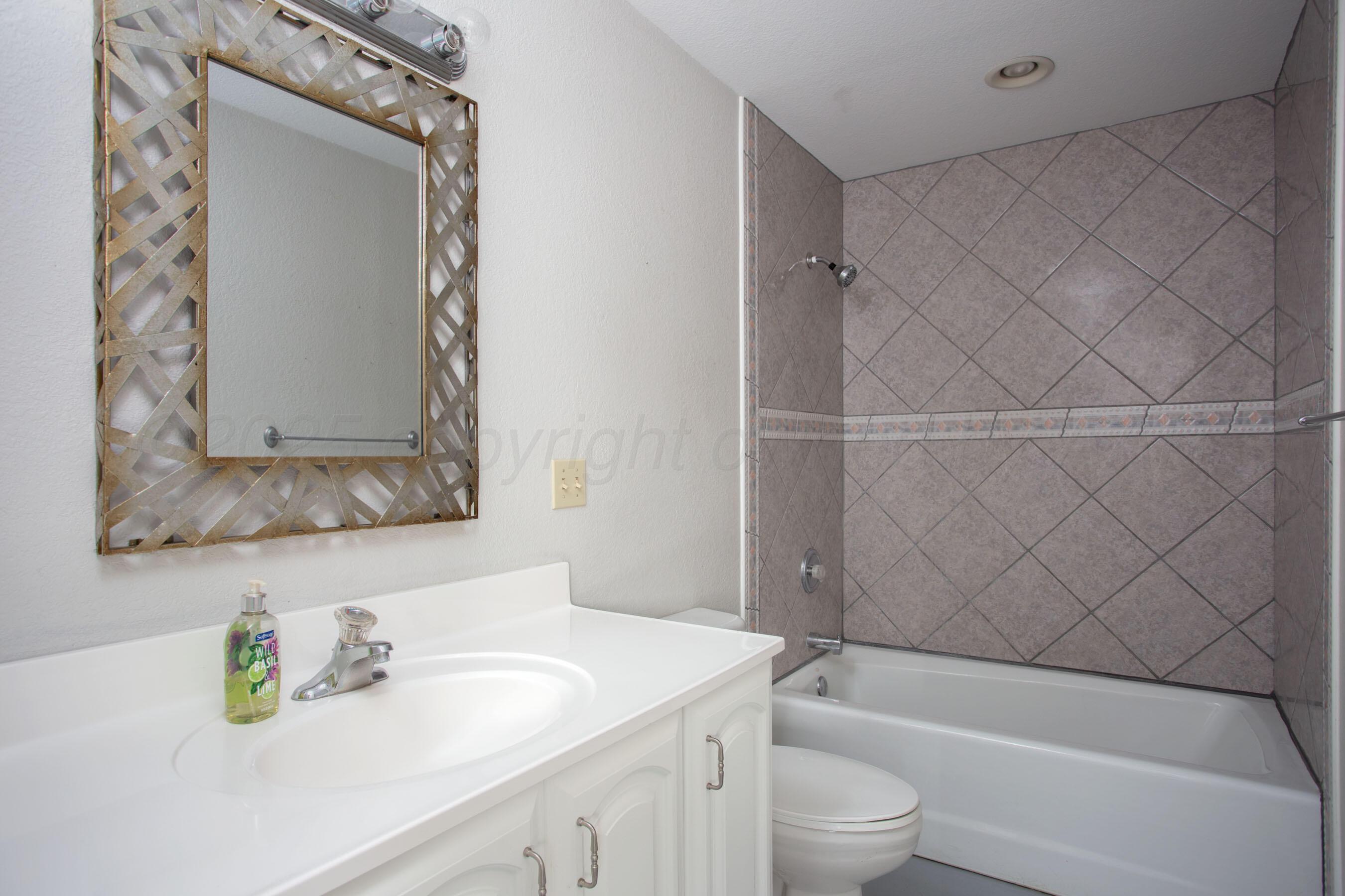 4823 Arden Road Amarillo, TX 79110 - Photo 47 of 53 a bathroom with a sink toilet and shower