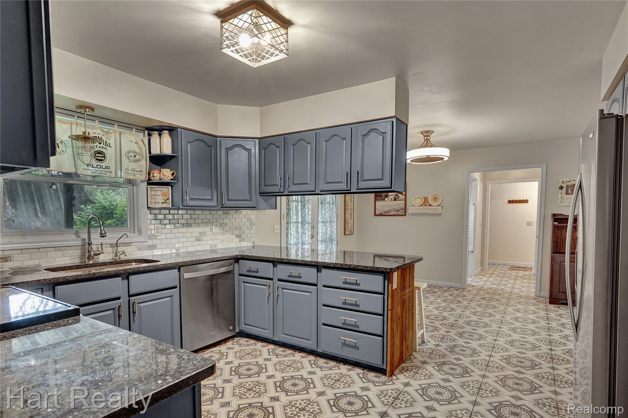 7167 Brown School Road North Branch, MI 48461 - Photo 16 of 51 Kitchen featuring extensive cabinetry, patterned floor tiling, and a subway tile backsplash