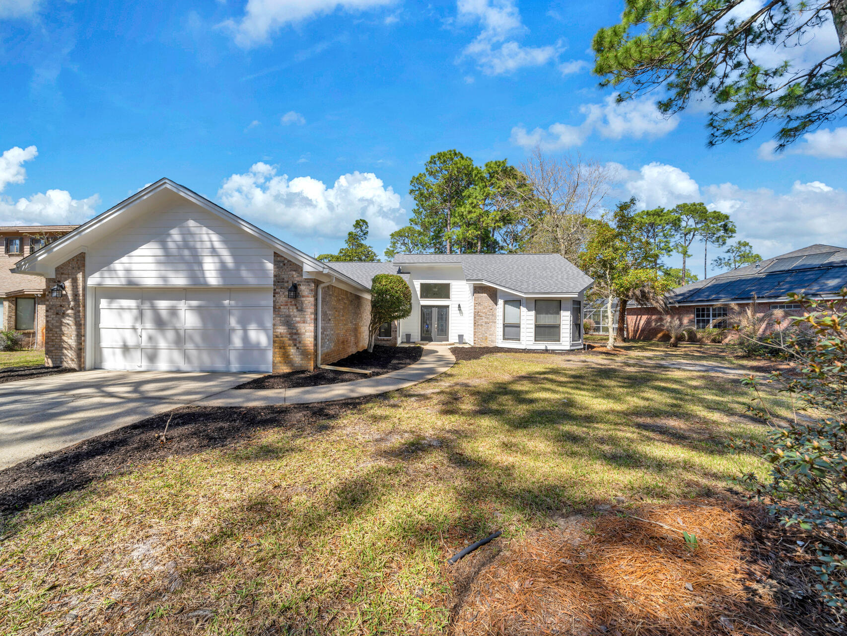 1182 Muirfield Way Niceville, FL 32578 - Photo 1 of 45 a front view of a house with a yard