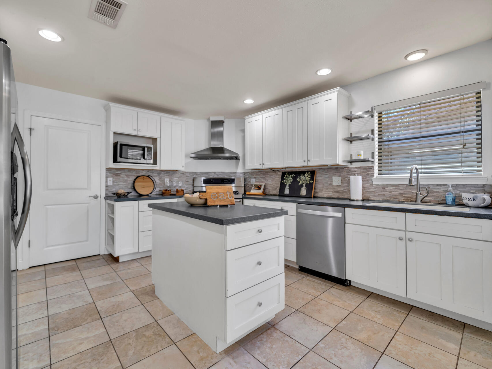 1182 Muirfield Way Niceville, FL 32578 - Photo 19 of 45 a kitchen with white cabinets stainless steel appliances and a sink