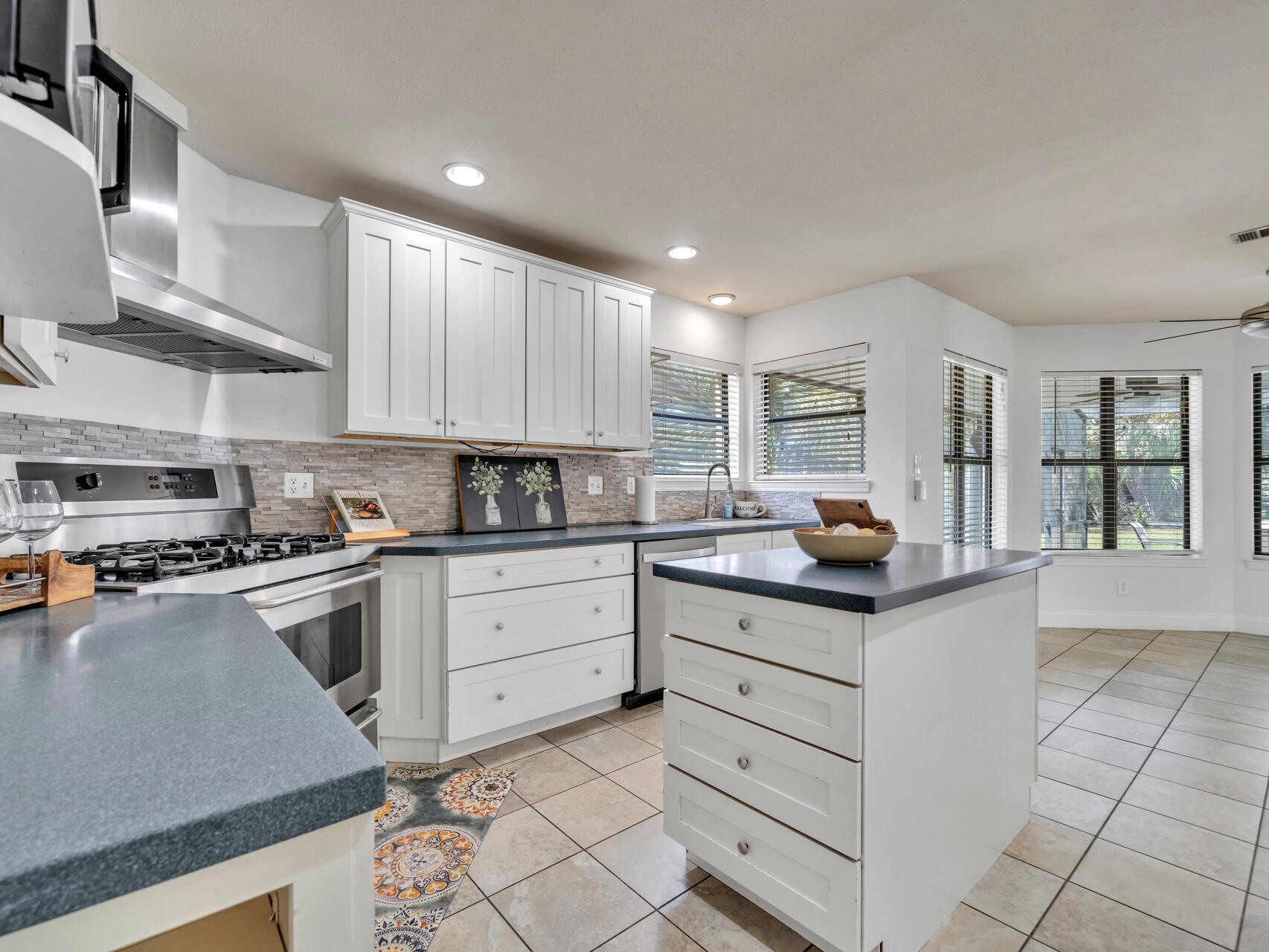 1182 Muirfield Way Niceville, FL 32578 - Photo 20 of 45 a kitchen with granite countertop white cabinets and white appliances