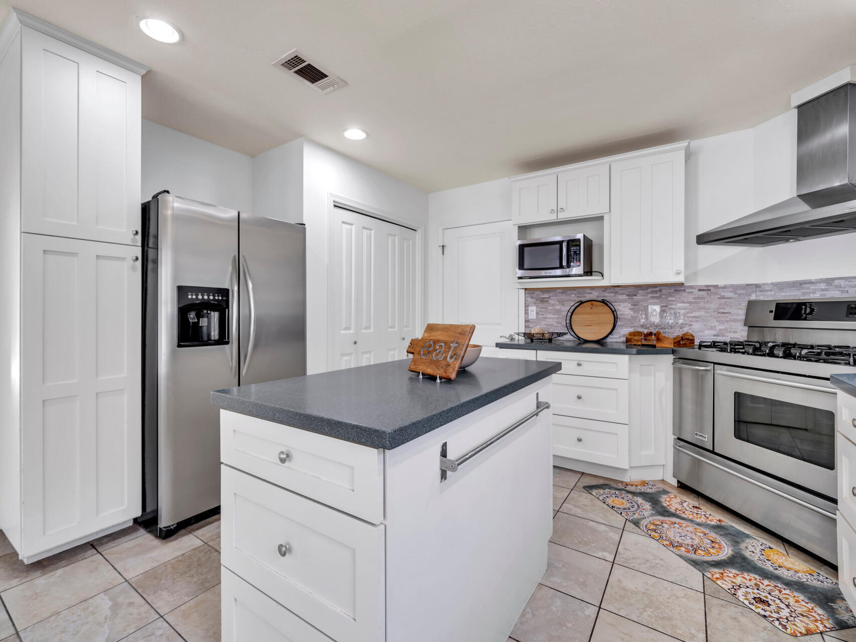 1182 Muirfield Way Niceville, FL 32578 - Photo 21 of 45 a kitchen with stainless steel appliances a stove refrigerator sink and microwave