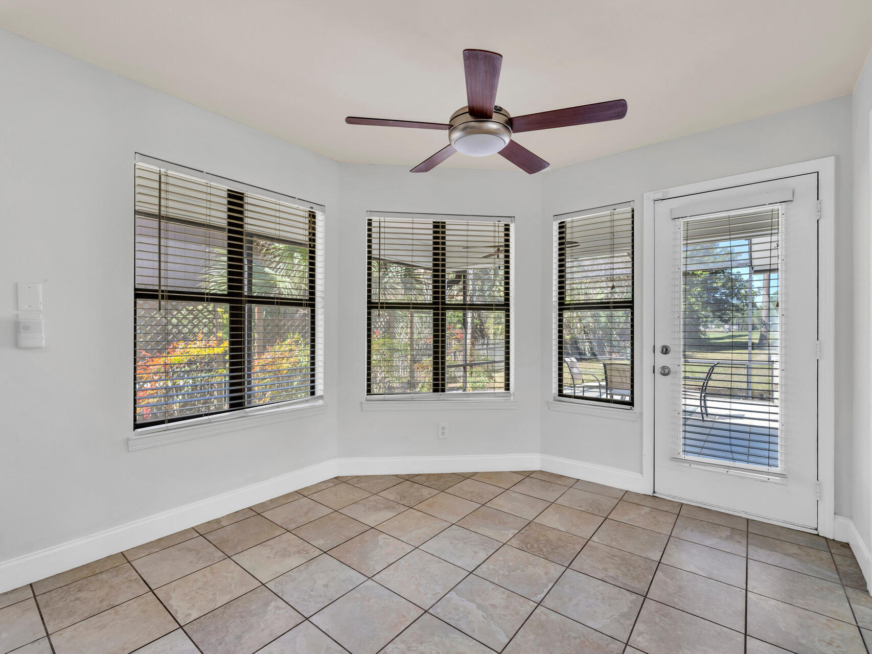1182 Muirfield Way Niceville, FL 32578 - Photo 23 of 45 a view of an empty room with a window and wooden floor