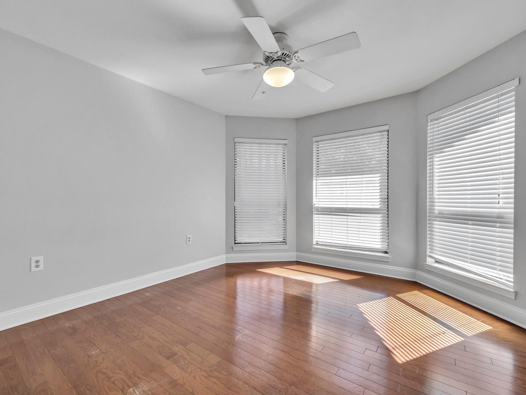 1182 Muirfield Way Niceville, FL 32578 - Photo 38 of 45 an empty room with wooden floor and windows