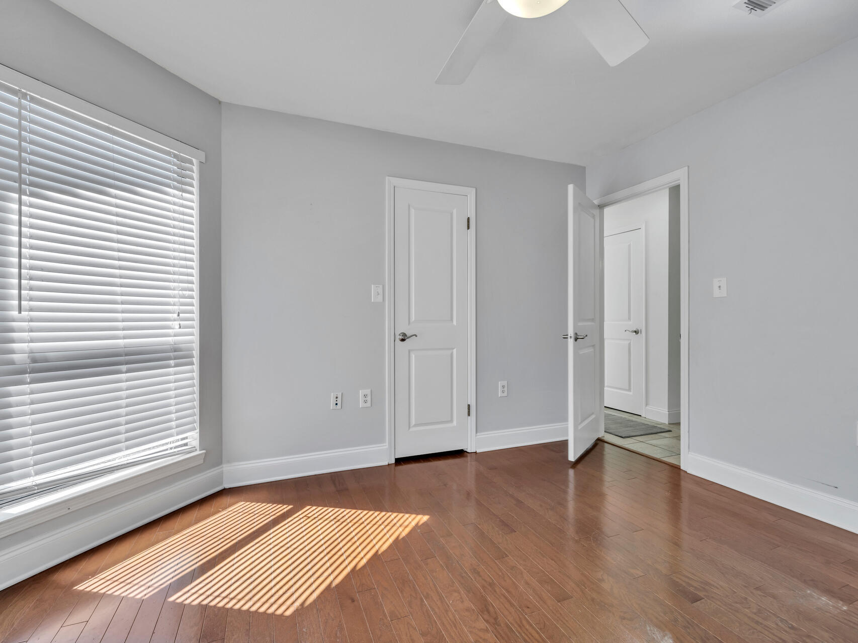 1182 Muirfield Way Niceville, FL 32578 - Photo 39 of 45 an empty room with wooden floor and windows