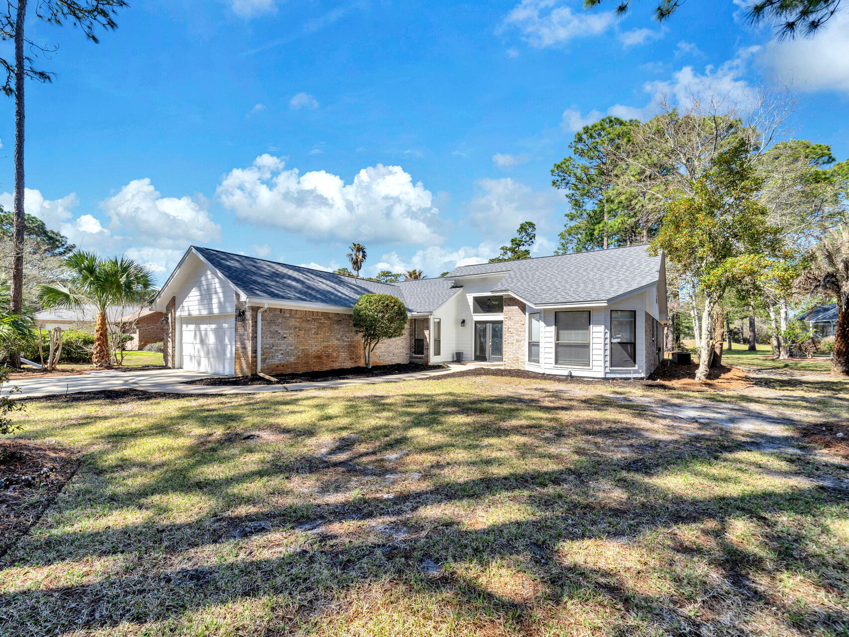 1182 Muirfield Way Niceville, FL 32578 - Photo 5 of 45 a front view of a house with a yard and garage