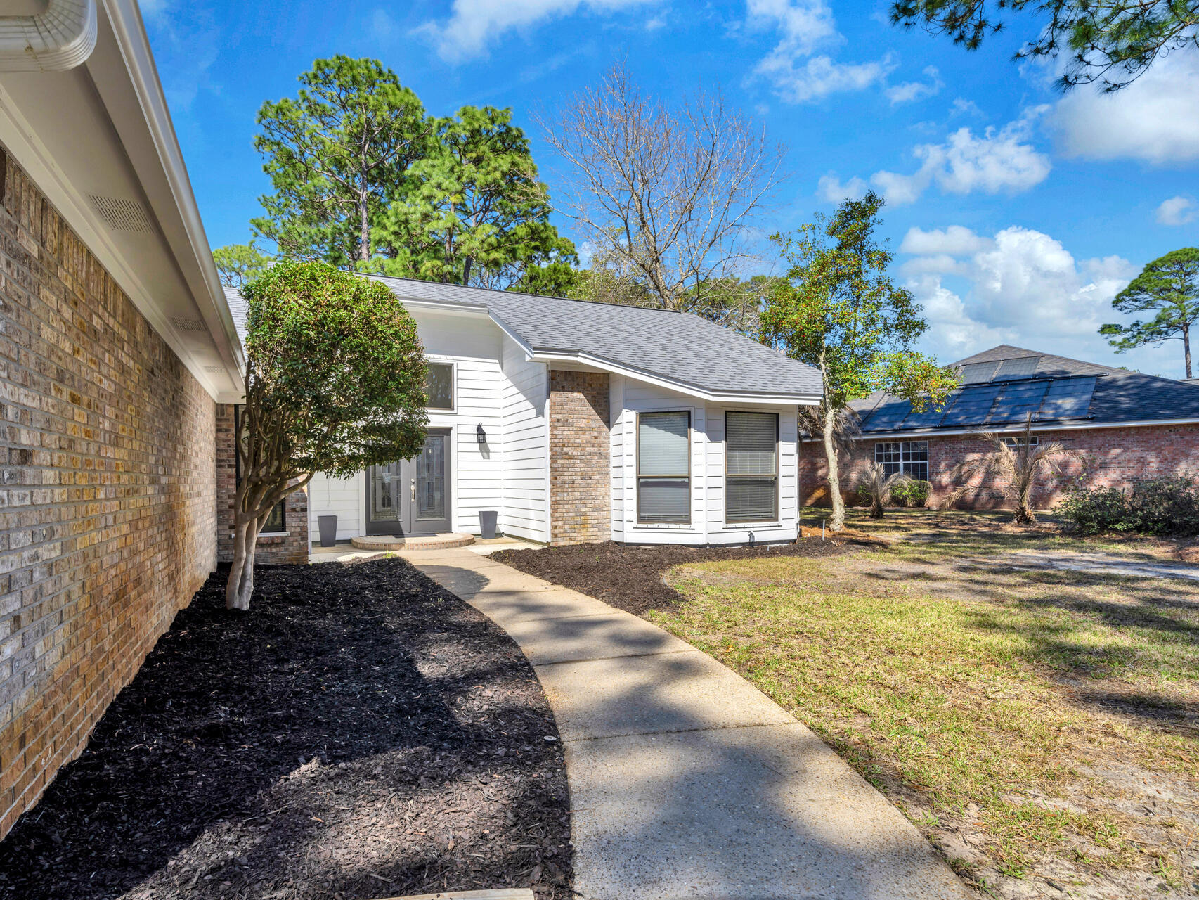 1182 Muirfield Way Niceville, FL 32578 - Photo 10 of 45 a front view of a house with a yard and garage