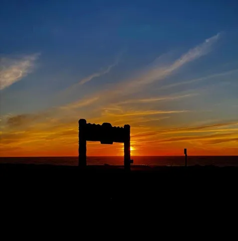 a large white kitchen with a large window appliances and cabinets