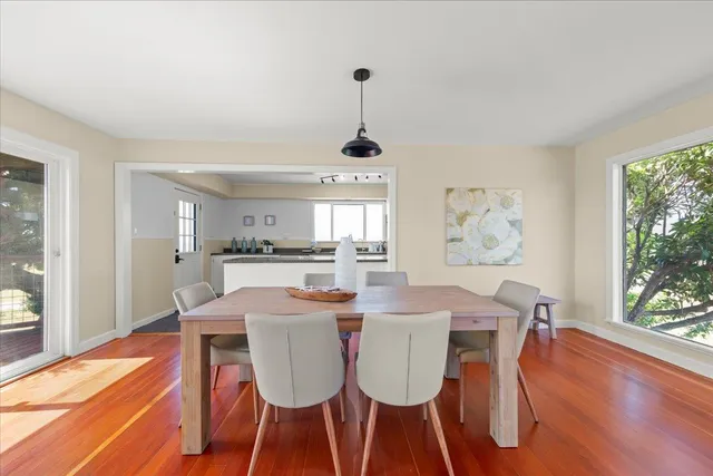 a bedroom with a large bed and wooden floor
