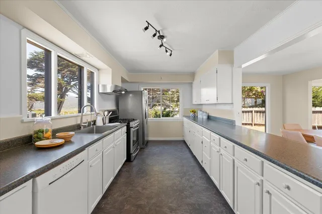 a view of a room with wooden floor and a window
