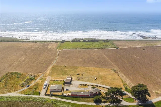 a view of a house with swimming pool and sitting area