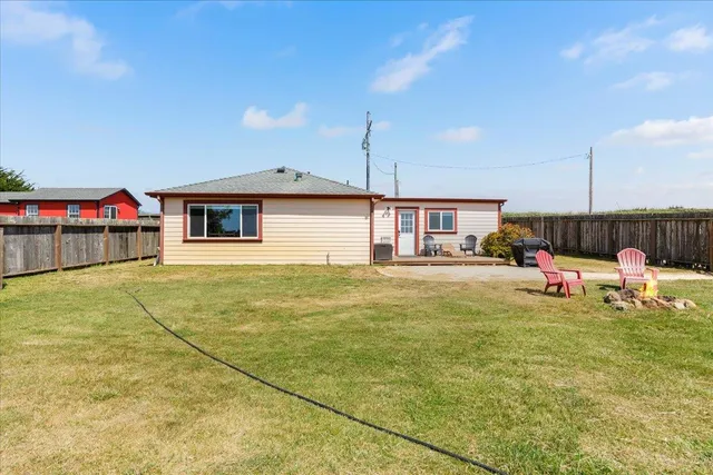 a living room with furniture and a view of kitchen