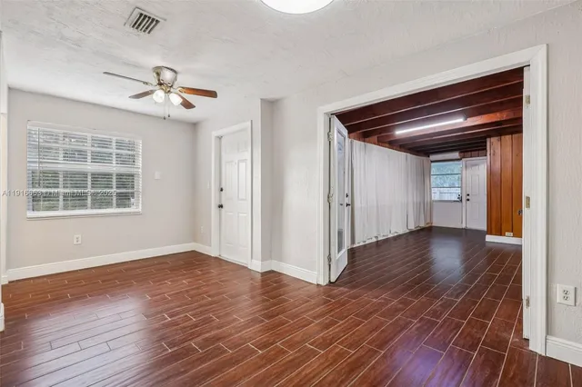 a view of kitchen with wooden floor and electronic appliances