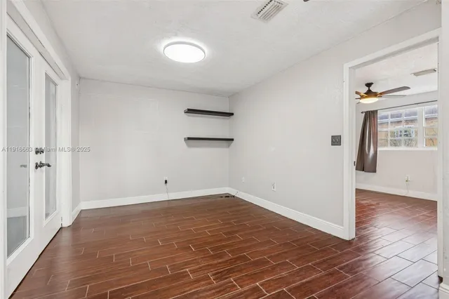 a kitchen with a stove cabinets and a window