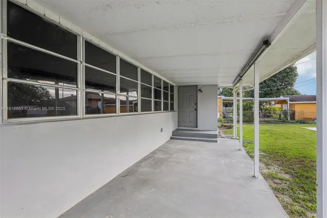 a view of a house with a big yard and large trees