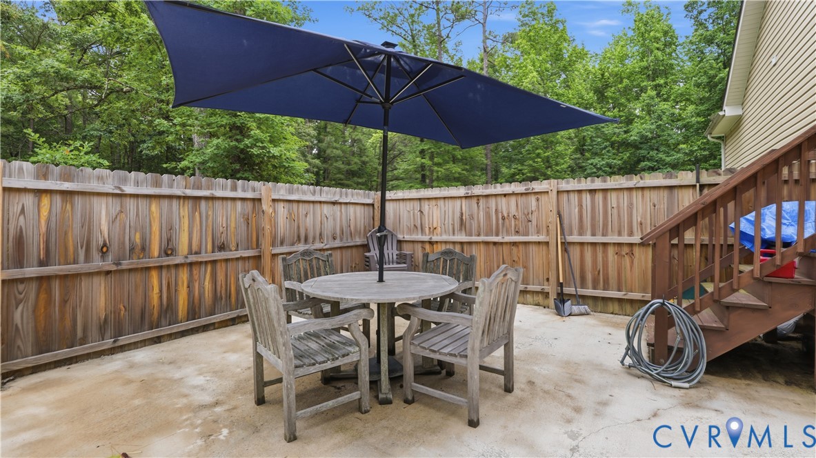 2406 Emanuel Church Road Powhatan, VA 23139 - Photo 36 of 48 Concrete patio area featuring a wooden privacy fen