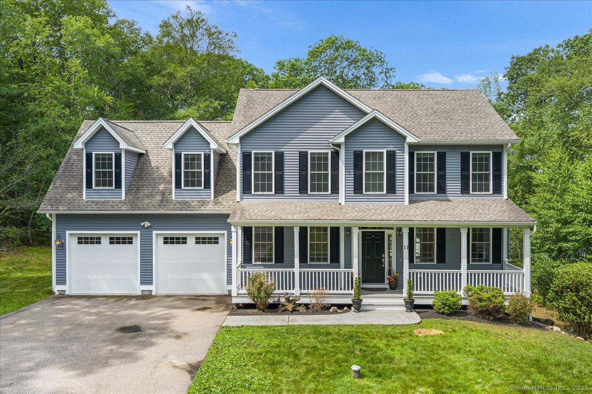 a front view of a house with garden and porch