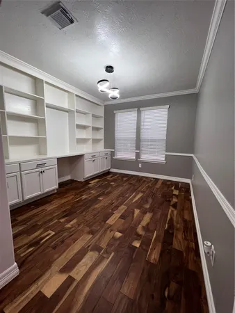 walk in closet with wooden floor