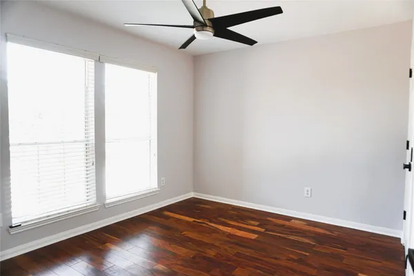 a view of an empty room with wooden floor