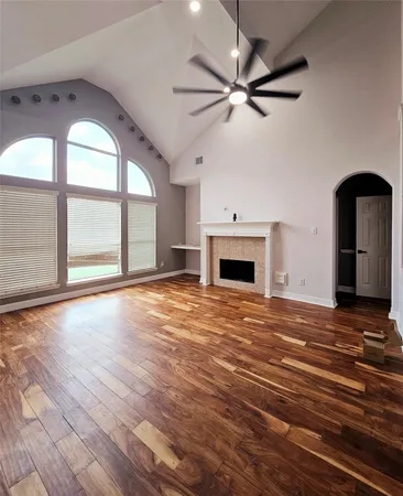 a view of an empty room with a fireplace and a window