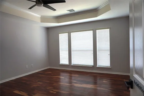 a view of an empty room and wooden floor