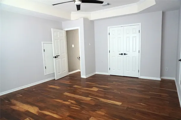 a view of a closet with wooden floor