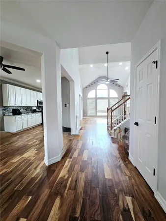 a view of a room with wooden floor and staircase
