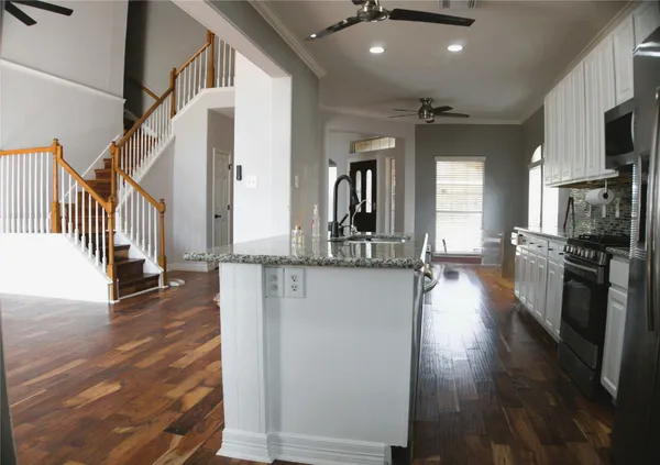 a view of a living room with fireplace and wooden floor